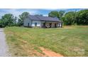 Spacious front yard with a view of a charming single-story home and well-maintained landscaping at 1138 Zeb Haynes Rd, Maiden, NC 28650