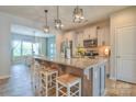 Modern kitchen with granite island, pendant lighting, stainless appliances, and open flow to dining area at 12531 Bryton Ridge Pkwy, Huntersville, NC 28078