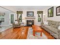 Inviting living room showcasing a fireplace with stylish tile and hardwood flooring at 130 Greenwich Dr, Statesville, NC 28677