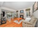 Cozy living room featuring a fireplace, hardwood floors, and comfortable furnishings at 130 Greenwich Dr, Statesville, NC 28677