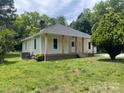 A quaint home with neutral-colored siding and a well-manicured lawn at 1327 Wiscassett St, Albemarle, NC 28001