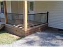 Close up of the front porch featuring black metal railings and stained wood base at 1327 Wiscassett St, Albemarle, NC 28001