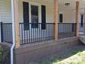 Close up of the front porch featuring black metal railings and stained wood base at 1327 Wiscassett St, Albemarle, NC 28001