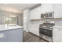 Modern kitchen featuring stainless steel appliances, white cabinets, and a stylish center island at 138 Lanyard Dr # B, Mooresville, NC 28117