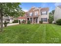 Well-maintained two-story house with a spacious front yard and a convenient two-car garage at 1572 Edenton Nw St, Concord, NC 28027