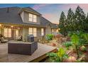 Inviting backyard with wooden deck, patio area, fire pit, grill and lush tropical landscaping for outdoor enjoyment at 1705 Townsend Ln, Rock Hill, SC 29730