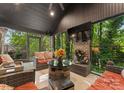 Relax in this inviting sunroom with cozy seating, a TV, and views of the serene backyard at 171 Secretariat Dr, Mooresville, NC 28117