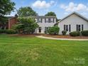 Charming two-story home with manicured lawn, tasteful landscaping and classic architectural details at 2223 Jon Chris Dr, Harrisburg, NC 28075