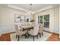 Inviting dining room featuring a decorative light fixture, lovely wall art and bright natural light at 2504 Korbel Ct, Waxhaw, NC 28173