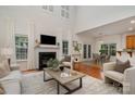 Bright living room boasts a fireplace, modern furnishings, and large windows with natural light at 2504 Korbel Ct, Waxhaw, NC 28173