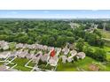 A high aerial shot showcases a neighborhood surrounded by trees, offering a sense of community at 2515 Walnut Forest Dr, Charlotte, NC 28216