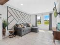 Cozy living room featuring stylish decor, large windows, tile floors, and comfortable seating at 2633 N Sharon Amity Rd, Charlotte, NC 28205