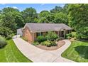 Aerial view of a brick home with a long driveway and mature trees at 2715 Kennetuck Ct, Charlotte, NC 28273