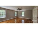 Bright bedroom featuring hardwood floors, neutral paint, and ample natural light at 2820 Bellhaven Cir, Charlotte, NC 28214