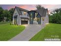 A modern two-story home featuring a gray roof, mixed siding, and a concrete driveway at 3078 Mountain Creek Dr, Sherrills Ford, NC 28673