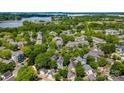 Expansive aerial view of the neighborhood, surrounded by lush greenery and a picturesque lake at 314 Center Dr, Davidson, NC 28036