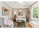 Cozy living room featuring neutral tones, a plush sofa, and a large window for natural light at 314 Center Dr, Davidson, NC 28036