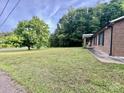 Expansive front yard with mature trees and a view of the home's welcoming porch at 35 Caldwell Dr, Taylorsville, NC 28681