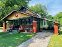 Charming home with a colorful exterior, inviting front porch, and convenient carport at 401 7Th St, Spencer, NC 28159