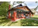 Charming home with a colorful exterior, inviting front porch, and convenient carport at 401 7Th St, Spencer, NC 28159