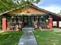 Charming home with a colorful exterior, inviting front porch, and convenient carport at 401 7Th St, Spencer, NC 28159
