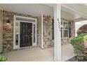 Close-up of the front door with stone accents, a porch column, and the house number at 4352 Haddington Dr, Fort Mill, SC 29707