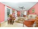 Cozy living room featuring neutral carpet, ceiling fan, and abundant light at 4630 Woodleaf Rd, Salisbury, NC 28147
