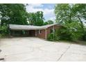 Brick home with covered parking featuring a spacious concrete patio at 466 Shiloh Church Rd, Hickory, NC 28601
