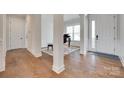 Elegant foyer showcasing beautiful hardwood floors, white trim, and access to various rooms at 4689 Kingswood Dr, Indian Land, SC 29707