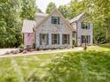 Charming white brick home with an attached garage, blue shutters, and manicured landscaping at 4715 Lenden Hall Ct, Gastonia, NC 28056