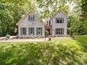 Beautiful white brick home with blue shutters, manicured lawn, and an American flag at 4715 Lenden Hall Ct, Gastonia, NC 28056