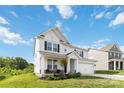 Charming two-story home featuring a well-manicured lawn, a covered porch, and a two car attached garage at 5121 Ennisworth Ln, Charlotte, NC 28214
