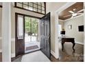Inviting front entryway with a hardwood floor, an ornate black front door and neutral decor at 524 Wildbrook Walk, Fort Mill, SC 29708