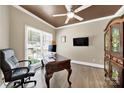 Home office featuring a ceiling fan, a large desk, a window, and hardwood floors at 524 Wildbrook Walk, Fort Mill, SC 29708
