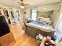 Comfortable main bedroom with a barn wood headboard, ensuite bath, and hardwood floors at 533 Tuckers Grove Rd, Statesville, NC 28625