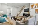 Cozy living area features a staircase, entertainment center, and contemporary furnishings at 7148 Hodges Meadow Ln, Charlotte, NC 28213
