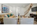 Bright living room showcases a staircase, sleek furnishings, and inviting decor at 7148 Hodges Meadow Ln, Charlotte, NC 28213