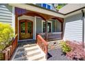 Inviting front porch featuring stylish wood trim and a beautiful wood-framed front door at 7435 Hammond Dr, Charlotte, NC 28215