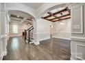Spacious living room with hardwood floors, coffered ceiling, and elegant archways at 7435 Hammond Dr, Charlotte, NC 28215