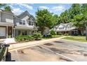 A well-maintained townhome with assigned parking, green landscaping, and a traditional exterior at 7504 Petrea Ln, Charlotte, NC 28227