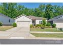 Inviting one-story home featuring a double garage and manicured lawn at 7530 Porrera St, Charlotte, NC 28214