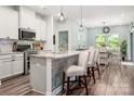 Open concept kitchen with a center island, pendant lighting, and a view to the dining area at 7530 Porrera St, Charlotte, NC 28214