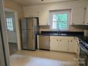 Classic kitchen offers stainless steel appliances and plenty of cabinet space providing functionality and style at 7608 Surreywood Pl, Charlotte, NC 28270