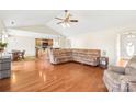 Open floor plan living room showcasing hardwood floors and a connection to the kitchen area at 8717 Swift Rd, Oakboro, NC 28129