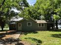 Quaint house with mature trees is situated on a beautiful lot with plenty of shade at 9401 Gold Hill Rd, Mount Pleasant, NC 28124