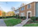 A well-kept townhome with a brick exterior, neat lawn, and inviting walkway, offering a classic curb appeal at 9464 Lexington Cir # B, Charlotte, NC 28213