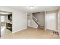 A bright living space with tile floors leads to the staircase and kitchen, offering an open and airy feel at 9464 Lexington Cir # B, Charlotte, NC 28213