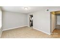 The home features a spacious, light-filled living area with tile flooring and neutral paint, awaiting personal touches at 9464 Lexington Cir # B, Charlotte, NC 28213