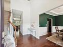 Inviting foyer with hardwood floors, an adjacent formal dining room, and a staircase to the upper level at 9507 Reid Hall Ln, Matthews, NC 28105