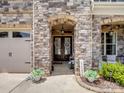 Charming home entrance with stone archway, double doors and manicured flower beds at 1006 Wellington Ave, Indian Land, SC 29707